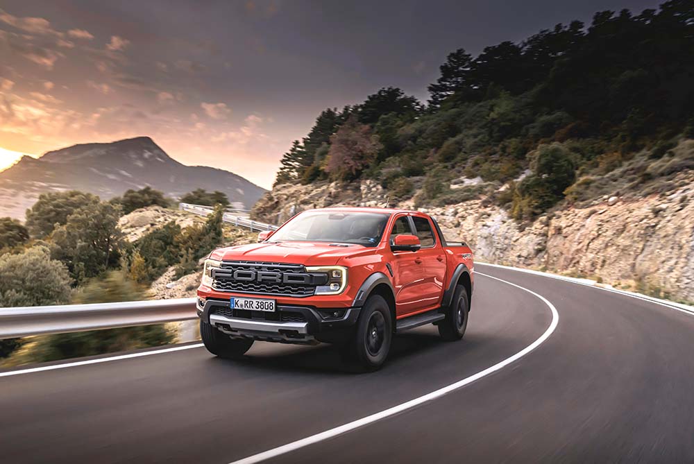 Red Ford F-150 on a winding road