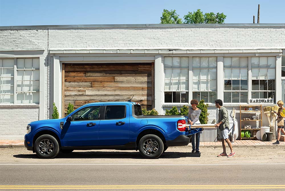 People loading products onto their pickup truck