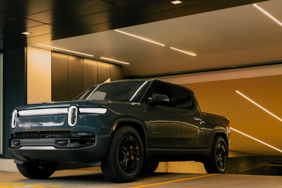 Rivian R1T driving out of a garage