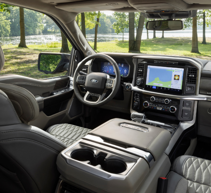 View from inside a pickup truck overlooking a meadow