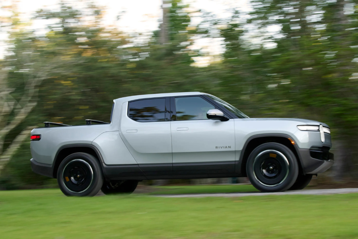 A silver Rivian R1T on the road