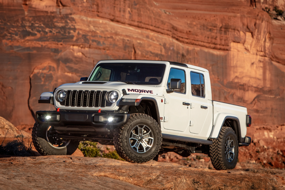 White Jeep Gladiator parked on a boulder